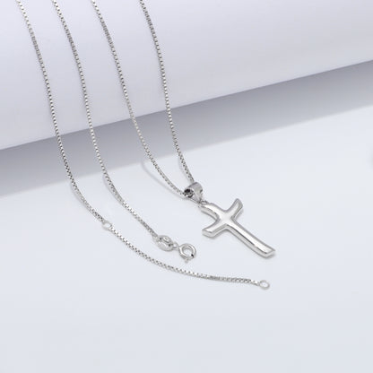 Silver cross necklace on a white background