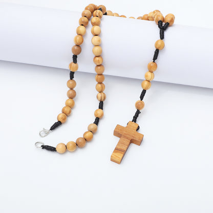 Olive wood rosary necklace with 8mm beads draped over a white block