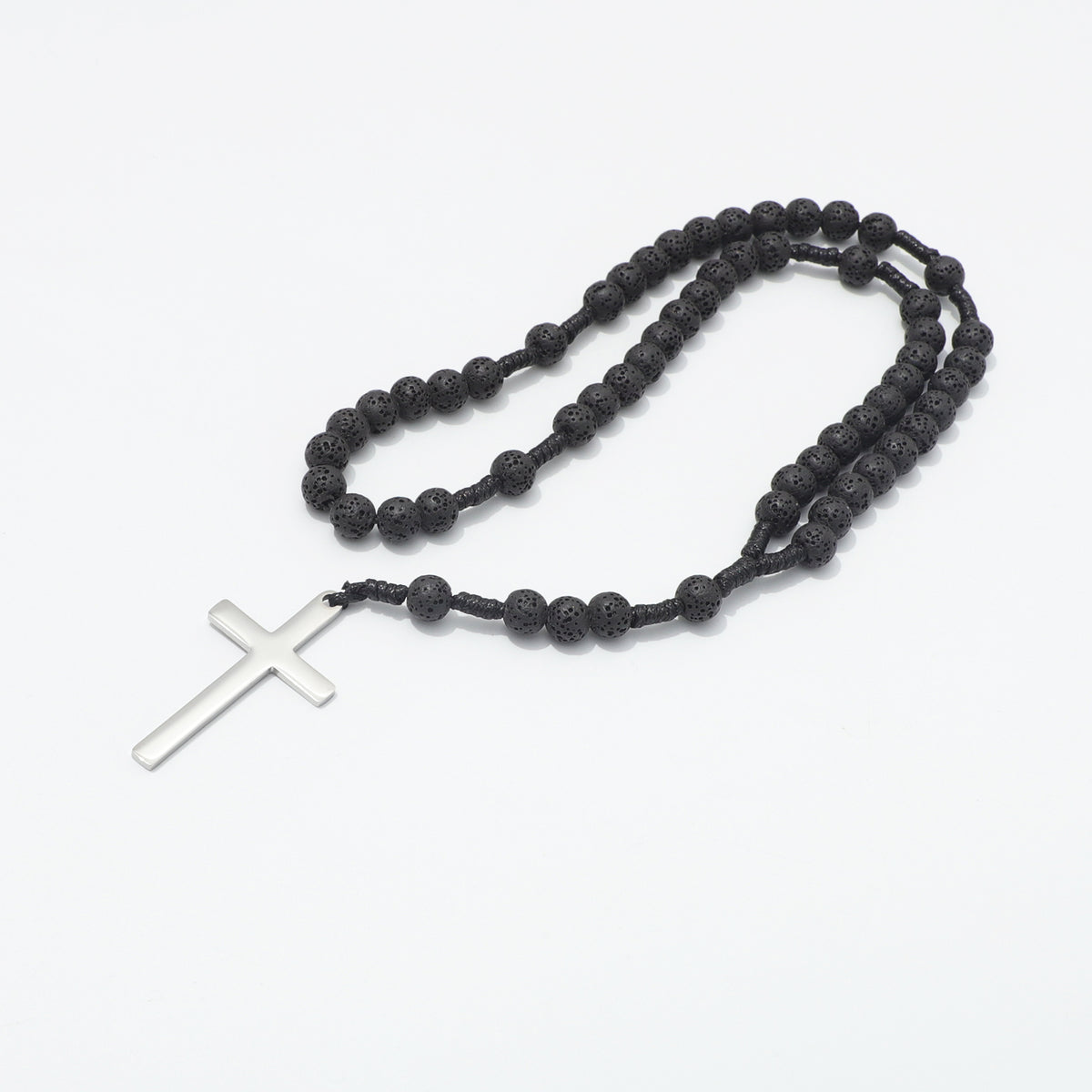Lava stone prayer rosary arranged in loops on a white background