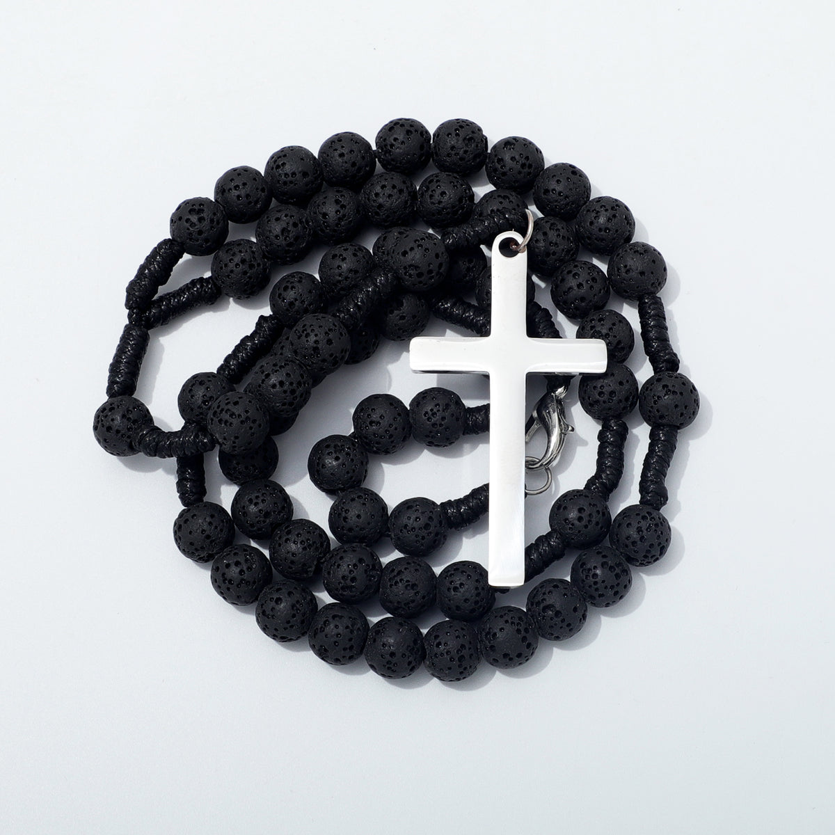 Coiled black lava stone rosary with a plain silver toned cross