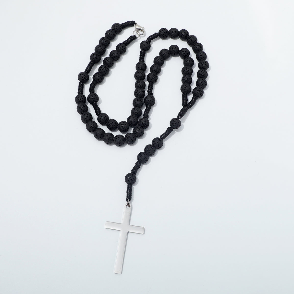 Lava stone rosary necklace arranged in loops with the clasp visible
