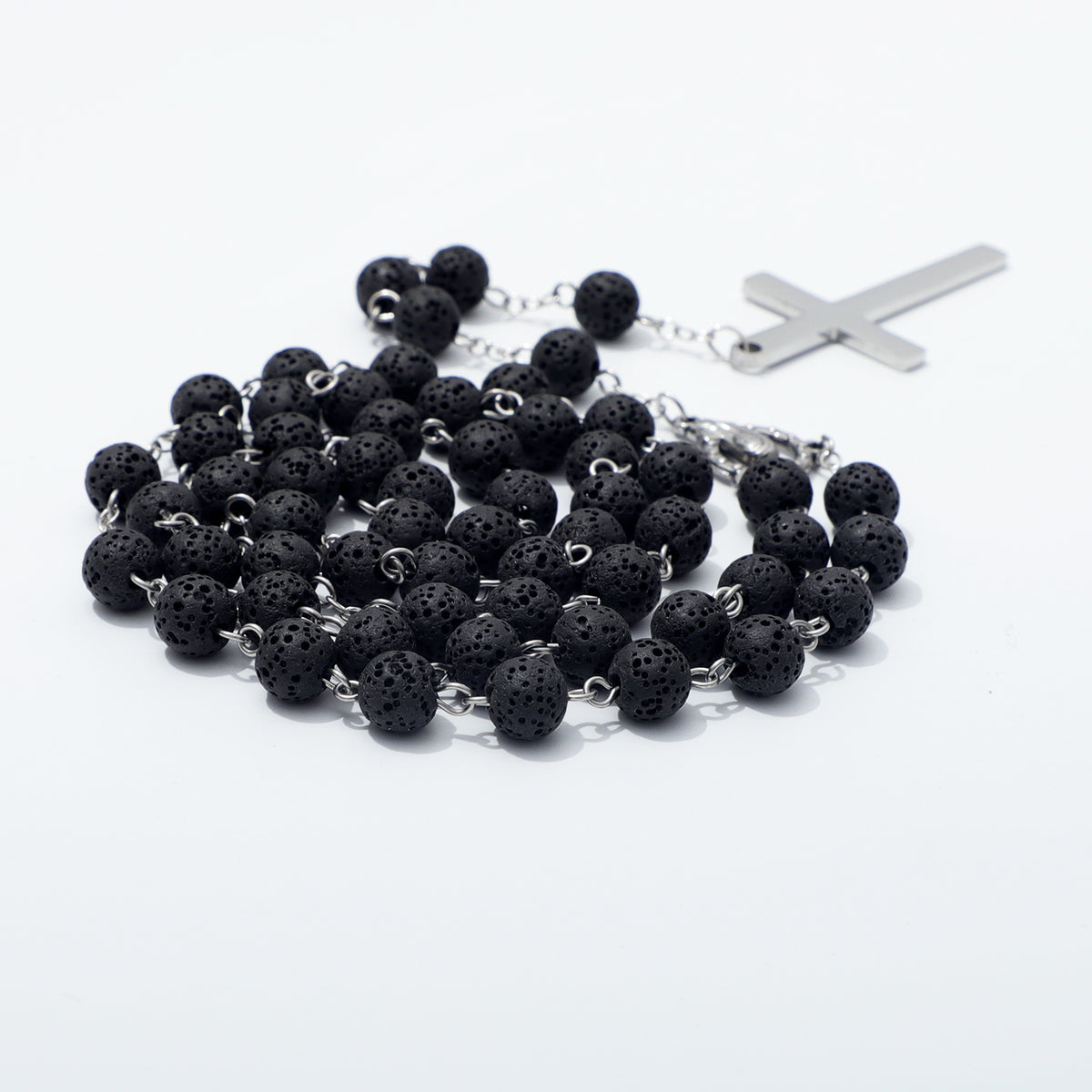 Close view of textured black lava beads on silver toned chain