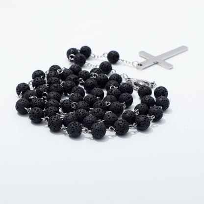 Close view of textured black lava beads on silver toned chain