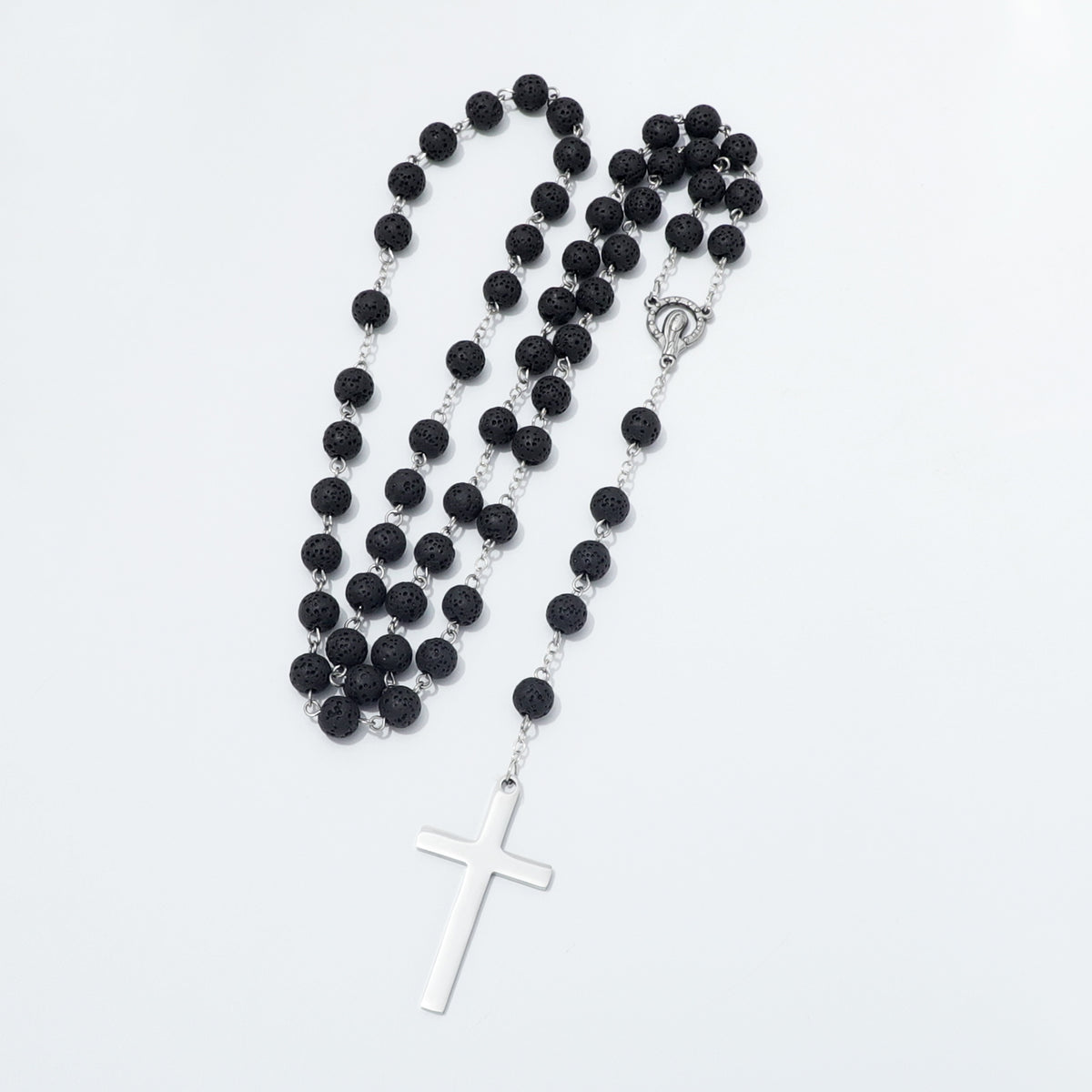 Lava stone rosary arranged in curves with Mary centerpiece and metal cross