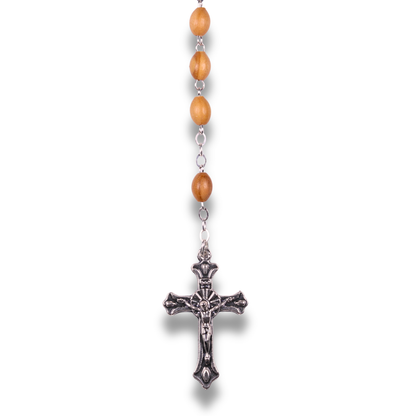 Detail of olive wood beads and an ornate silver toned crucifix