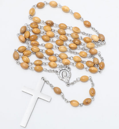 Oval olive wood rosary arranged beside a Virgin Mary centerpiece and plain metal cross