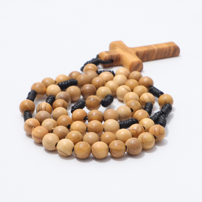 Side view of coiled olive wood pocket rosary beads