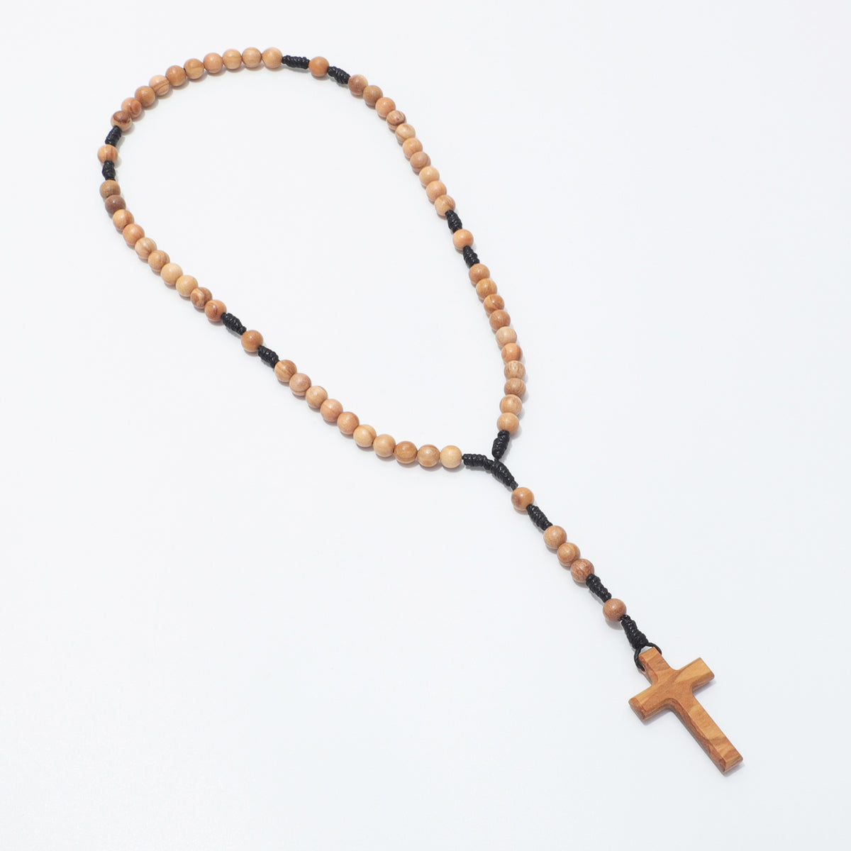 A wooden rosary with light brown wooden beads and a matching wooden cross, separated by black cord, displayed on a clean white background.