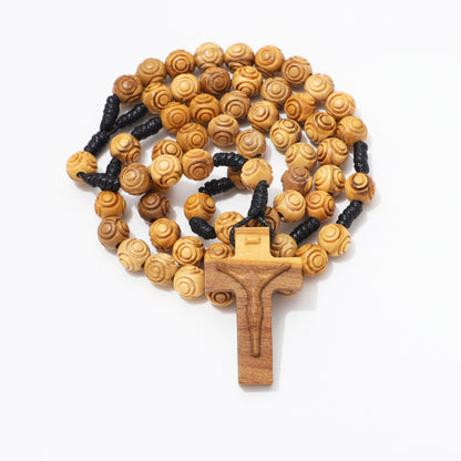 Coiled engraved olive wood rosary with carved crucifix and black knotted cord