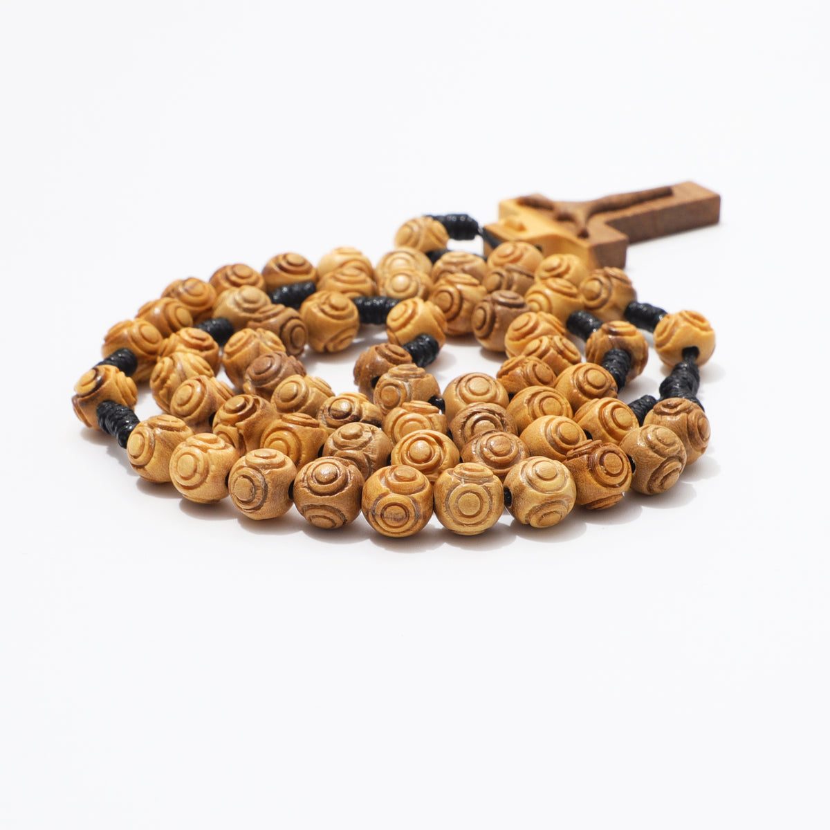 Side view of coiled 8mm engraved olive wood rosary beads with carved crucifix