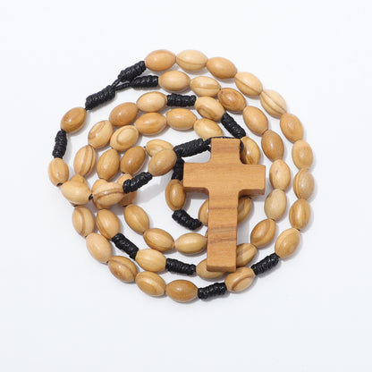 Coiled oval olive wood rosary with a wooden cross and black knotted cord