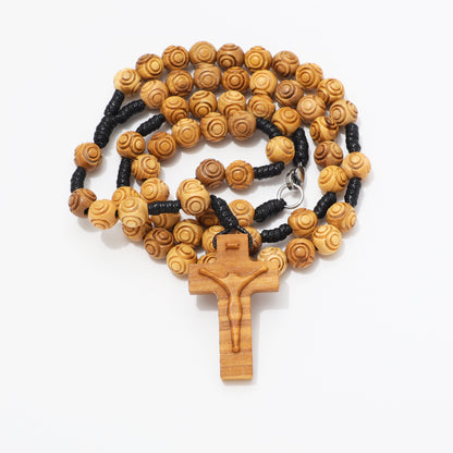 Coiled 8mm engraved olive wood rosary necklace showing the carved crucifix and clasp