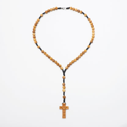 Engraved olive wood rosary necklace with 8mm beads laid out on a white background