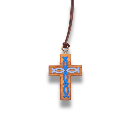 Olive wood cross pendant with blue fish symbols on a brown cord against a white background