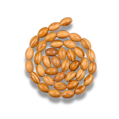 Wooden beads arranged in a circular pattern on a white background