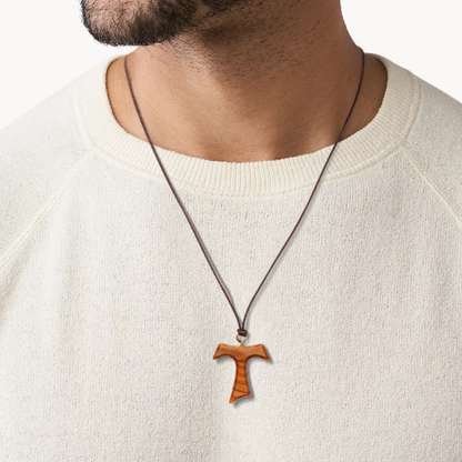 Man wearing Tav Cross Olive Wood Necklace