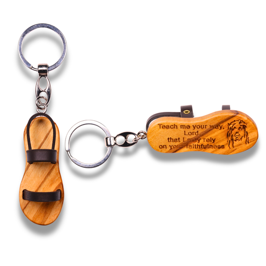 Wooden sandal keychain with engraved text on a white background