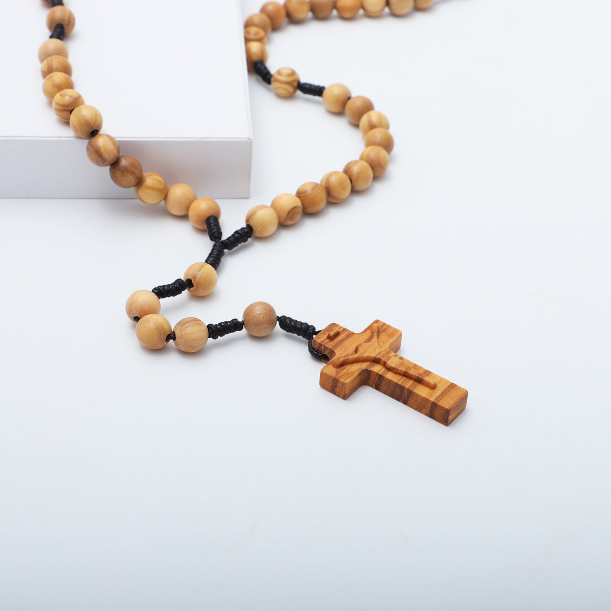 Close view of the carved olive wood crucifix and round beads