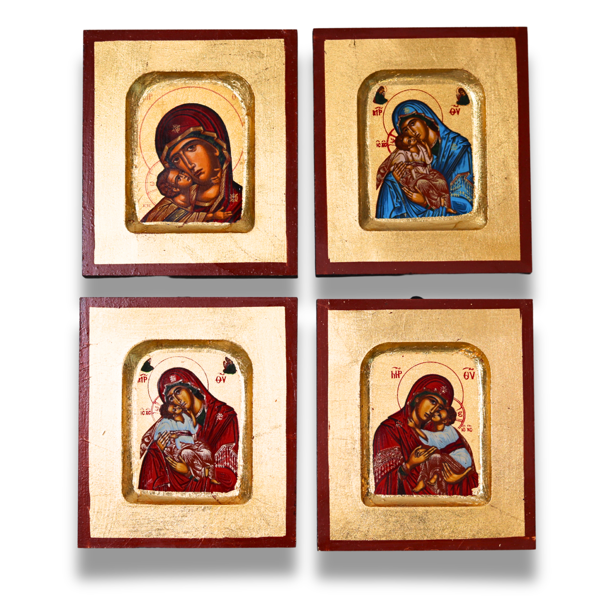 Set of four religious icon paintings in wooden frames on a white background