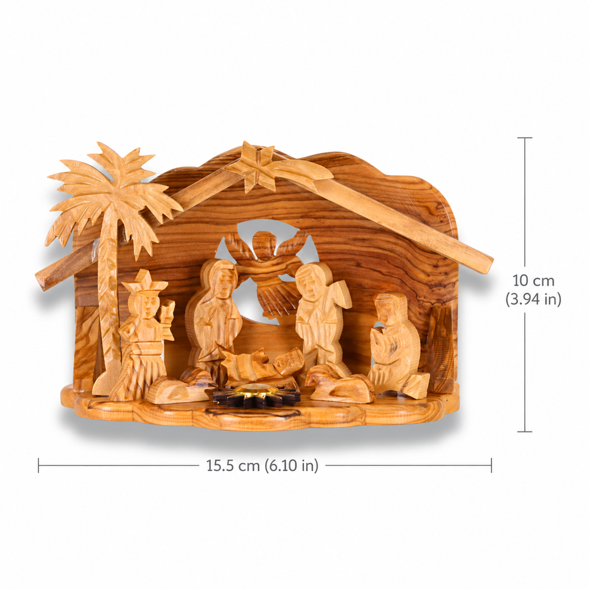 Carved olive wood nativity scene with a stable, palm tree, and figurines, shown with dimension lines indicating 15.5 cm width and 10 cm height on a white background.