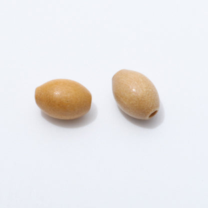 Close up of two 6 × 9mm oval olive wood beads on a white background