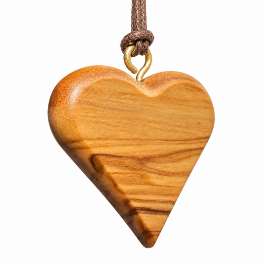 Angled view of the Ahavah olive wood heart pendant, showing its rounded edges, polished finish and brown cord.